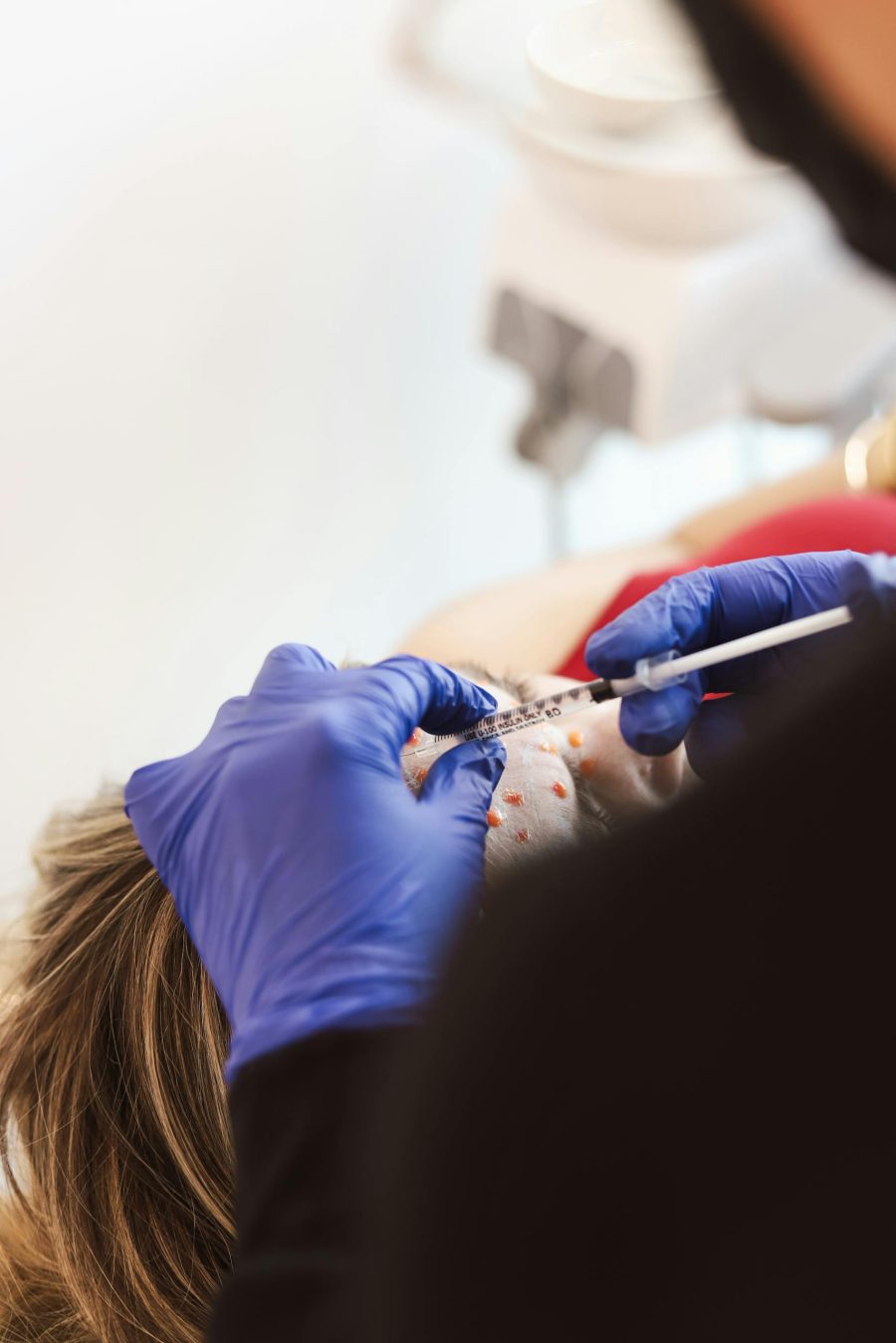 a-medical-professional-performs-a-facial-injection-on-a-patient-in-a-clinic-setting.-27925593-scaled